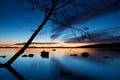 Tree silhouette leaning over Pyhajarvi lake in Tampere