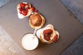 Tree stacks of mini pancakes with strawberry and chocolate on bl Royalty Free Stock Photo