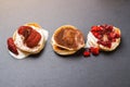 Tree stacks of mini pancakes with strawberry and chocolate on bl Royalty Free Stock Photo