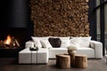 Tree stump coffee table near white sofa and pouf against wood paneling wall with fireplace and stack of firewood