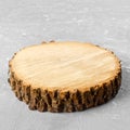 Tree stump round cut with annual rings on gray background from top view Royalty Free Stock Photo