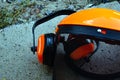 Tree surgeon tools on desk including chainsaw, helmet, harness, ear defenders and rope Royalty Free Stock Photo