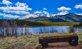 A tree trunk bench against the backdrop of the snow-capped Pikes Peak mountains, Colorado, US Royalty Free Stock Photo