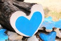 The tree trunk is n the shape of a heart painted with blue and white paint.