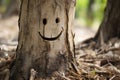 a tree trunk with a smiley face carved into it Royalty Free Stock Photo
