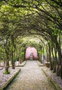 Tree tunnel with walkway and statue Royalty Free Stock Photo