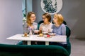 Tree young pretty women best friends. Horizontal shot of beautiful women talking and having fun while drinking coffee Royalty Free Stock Photo