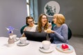 Tree young pretty women best friends. Horizontal shot of beautiful women talking and having fun while drinking coffee Royalty Free Stock Photo