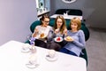 Tree young pretty women best friends. Horizontal shot of beautiful women talking and having fun while drinking coffee Royalty Free Stock Photo