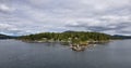 Treed Island with Homes, boats and docks, nearby smaller island with lighthouse Royalty Free Stock Photo