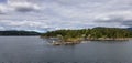 Treed Island with Homes, boats and docks, nearby smaller island with lighthouse Royalty Free Stock Photo