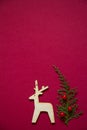 Treeline shape made of thuja branches and wooden figure of deer. Minimal winter creative table flat lay Royalty Free Stock Photo