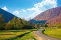 trees along the countryside valley. beautiful autumn scenery in mountains. forest on hills in fall colors Royalty Free Stock Photo