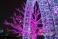 Trees and archways decorated with glowing purple neons