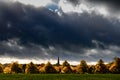 Autumn trees under a dark sky Royalty Free Stock Photo