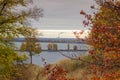 Trees with autumn leaves on hill over reservoir Royalty Free Stock Photo