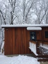 Trees branches on house in winter snow storm