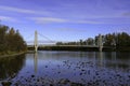 Trees and a bridge in autumn along a river Royalty Free Stock Photo