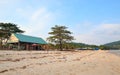 Trees, buildings and rubnish on Sao beach, Phu Quoc, Vietnam - December 2018. Royalty Free Stock Photo