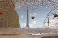 Trees and the Eiffel tower reflected in a puddle Royalty Free Stock Photo