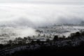 Trees and fields covered in fog on an atmospheric, moody winters day. Malvern Hills, UK Royalty Free Stock Photo