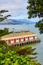 Trees framing a warehouse on a dock with a tour boat on San Francisco Bay Royalty Free Stock Photo