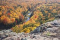 Trees in full autumn color and a small river viewed from rocky o Royalty Free Stock Photo