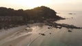 Trees growing on a rock surrounded by sea on sunset sky background. Shot. Cliff covered by green trees on wonderful Royalty Free Stock Photo