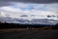 Trees and mountains behind the Alaska Highway Royalty Free Stock Photo