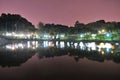 Trees with night light reflection on the pond Royalty Free Stock Photo