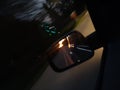 Trees paved path sunset reflection car mirror  bad weather Royalty Free Stock Photo