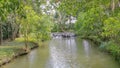 The trees and pond are in the garden that is beautiful