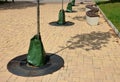 The trees provided the gardener with a watering bag, which gradually releases water in a valve in a public park in the square