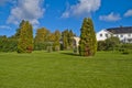 Trees, shrubs and hedges in the garden of red mansion Royalty Free Stock Photo