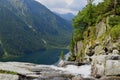 Trees, waterfall and blue lake in the mountains Royalty Free Stock Photo