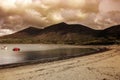 Trefor beach and harbour in Gwynedd, North Wales, with Snowdonia mountains in the background.