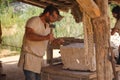 Treigny, France - July 13 2019 : Worker carving stones at the Guedelon castle. This site is actually under construction, as an