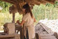 Treigny, France - July 13 2019 : Worker carving stones at the Guedelon castle. This site is actually under construction, as an