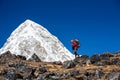Trekker approaching PumoRi mountain in Khumbu valley on a way to