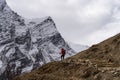 A trekker with backpack trekking in Manaslu circuit, Himalaya mountains range in Nepal Royalty Free Stock Photo
