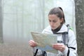 Trekker checking map in a forest