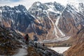 Trekker goes down fron Larke La pass on Manaslu circuit trek in Royalty Free Stock Photo