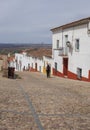 Trekker going down a steep street of Hornachos, Spain