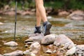 Trekker legs walking crossing river Royalty Free Stock Photo