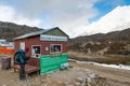 Trekker pay for room in lodge od Lobuche village before entry on Royalty Free Stock Photo