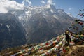 Trekker standing in prayer flags in Nepal Everest region Royalty Free Stock Photo