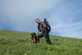 Trekker standing on top of the hill with backpack