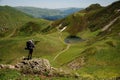 Trekker stands on top of the rock Royalty Free Stock Photo