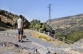 Trekker walking along Poqueira Gorge. Las Alpujarras Region, Gra