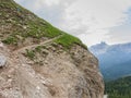 Trekker walking on path upon dolomitic rock wall, Tofana Mountain Group